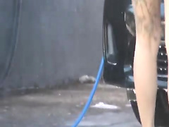 Sexy and horny brunette at the car wash
