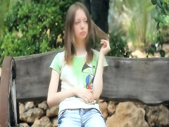 Ultra skinny girl teasing on a bench