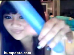 Beautiful asian teen plays with her toy