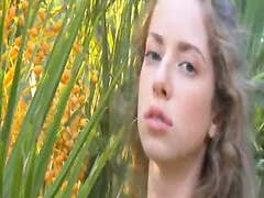 Beauty masturbating in the grass