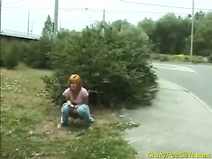 Red head lady taking a pee outdoors